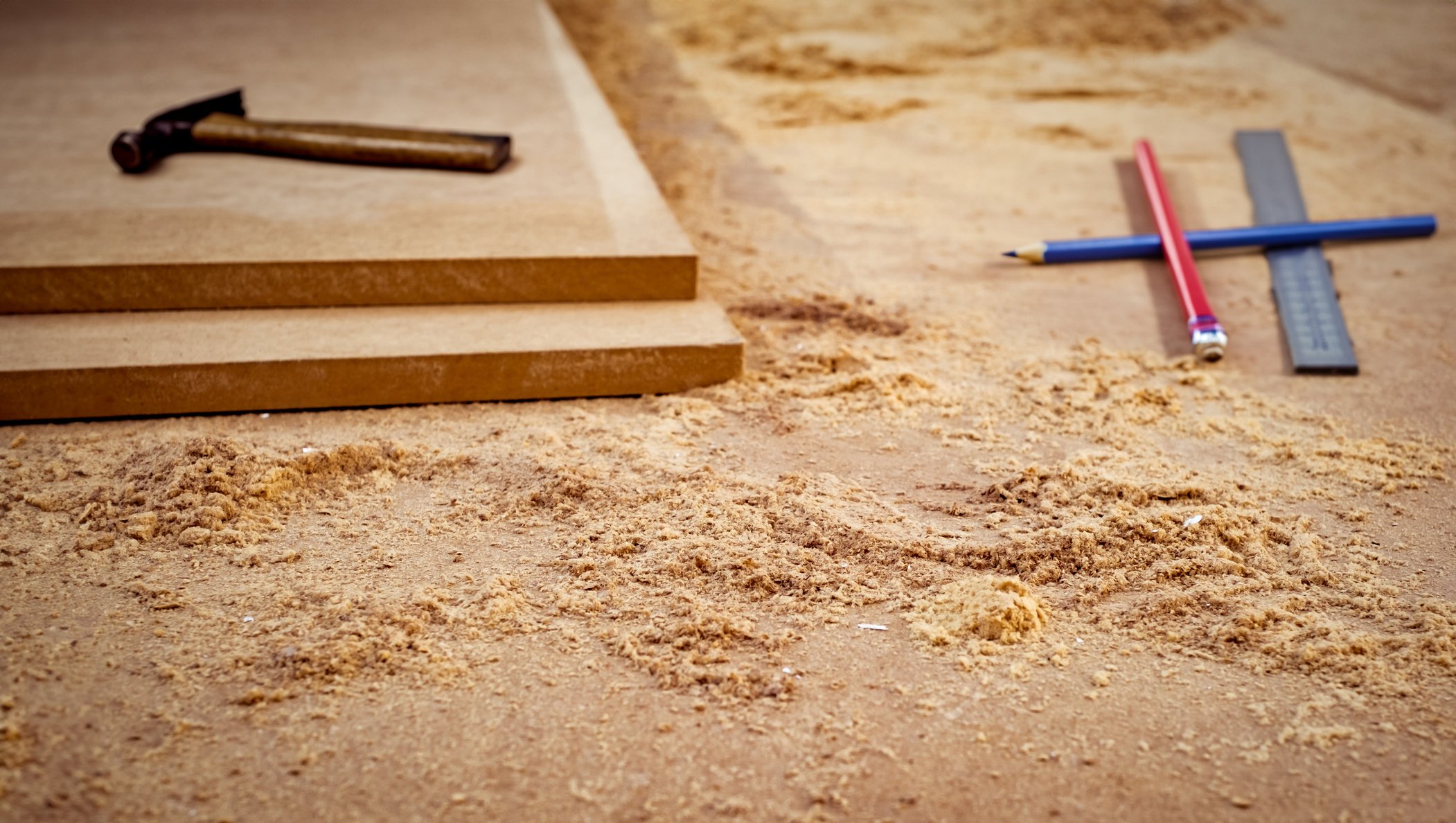 MDF chipboard with woodworking tools and sawdust